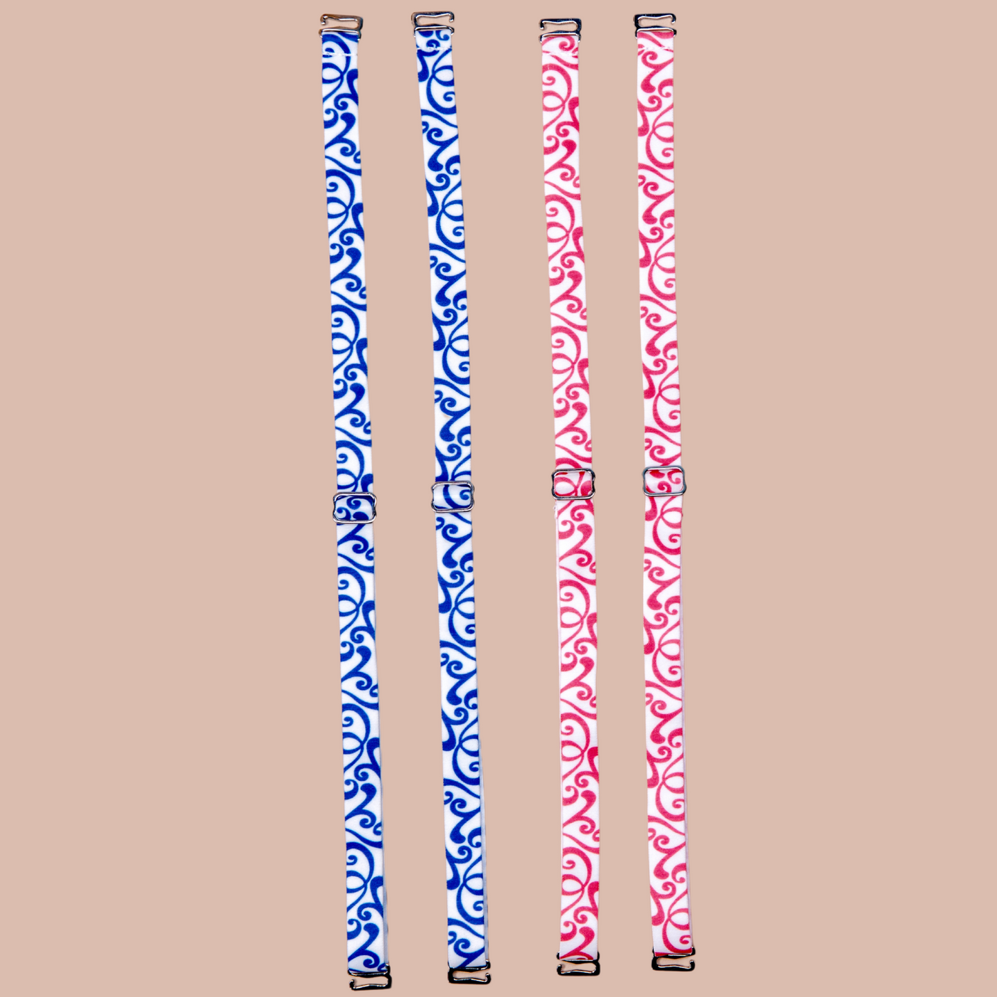 Right: Roll'n Blues Her-Rah Straps - white straps with blue swirling pattern. Left: Rock'n Red Her-Rah Straps - white straps with red swirling pattern.