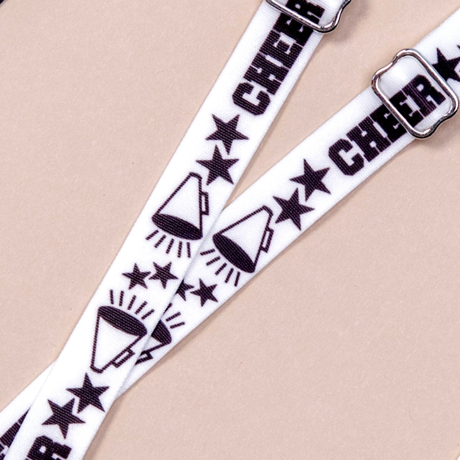 White straps with megaphones, black stars and the word Cheer in black block letters, alternating along length of material, featuring silver metal hardware.