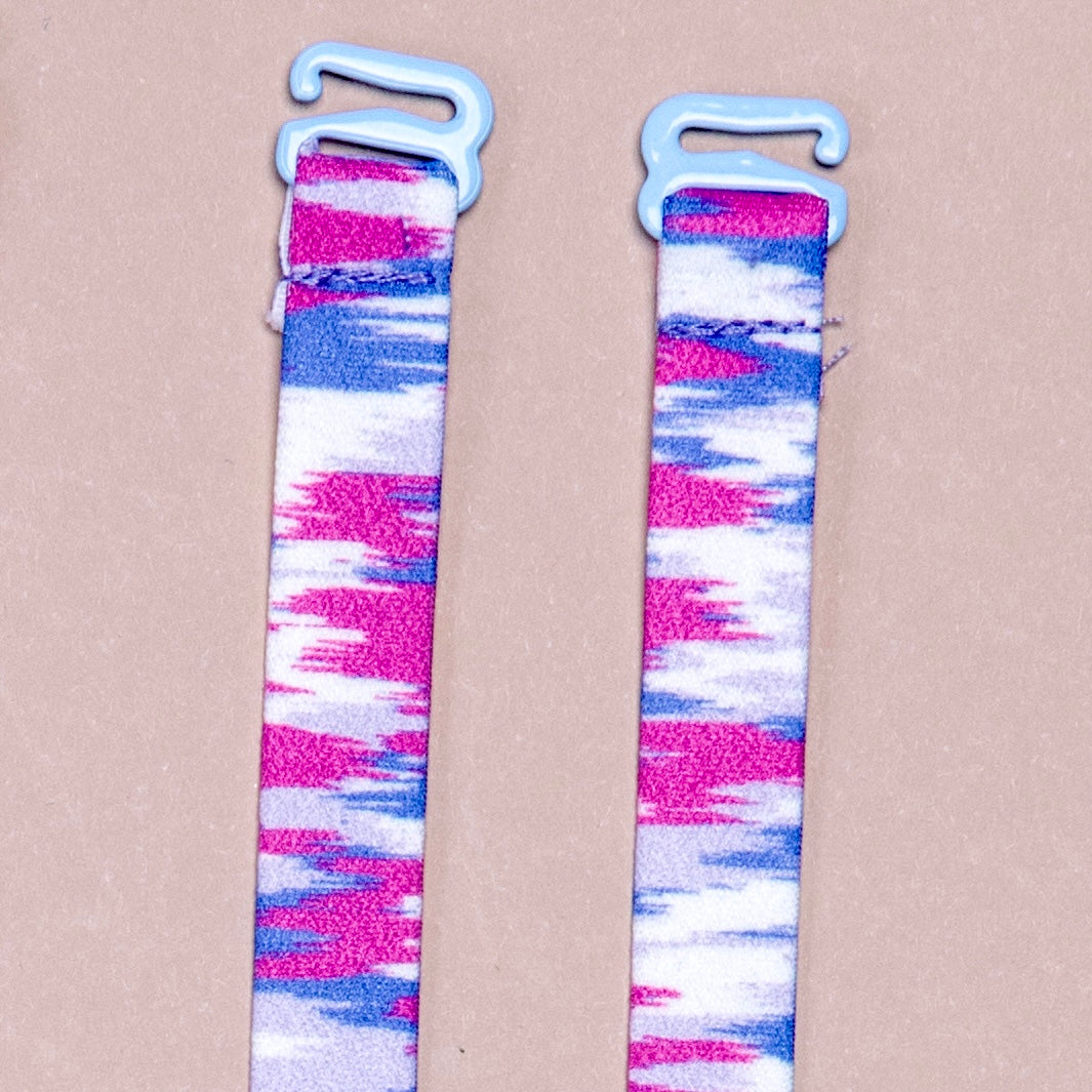  3-D Static - White straps with fading static/sound wave shapes in hot pink, gray, and blue, featuring blue coated hardware.