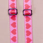 Hearts - pink straps with red hearts repeating the length of the strap, featuring silver metal hardware.