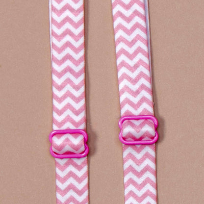 Close up on a set of interchangeable her-rah bra straps in chevron patterns with alternating stripes of flamingo Pink and white.