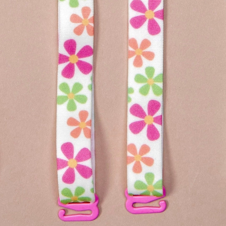 May Flowers Her-Rah bra Straps - white straps with a mix of daisy like flowers in green, orange and pink with yellow center, featuring pink coated hardware.